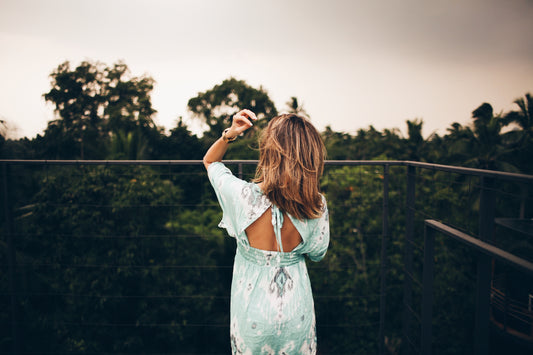 Woman In Blue Floral Dress Wearing Womens Layered Necklaces