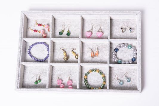earrings and bracelets in a box in different jewellery colours and patterns