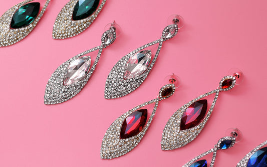 different pairs of statement stud earrings in varying colours
