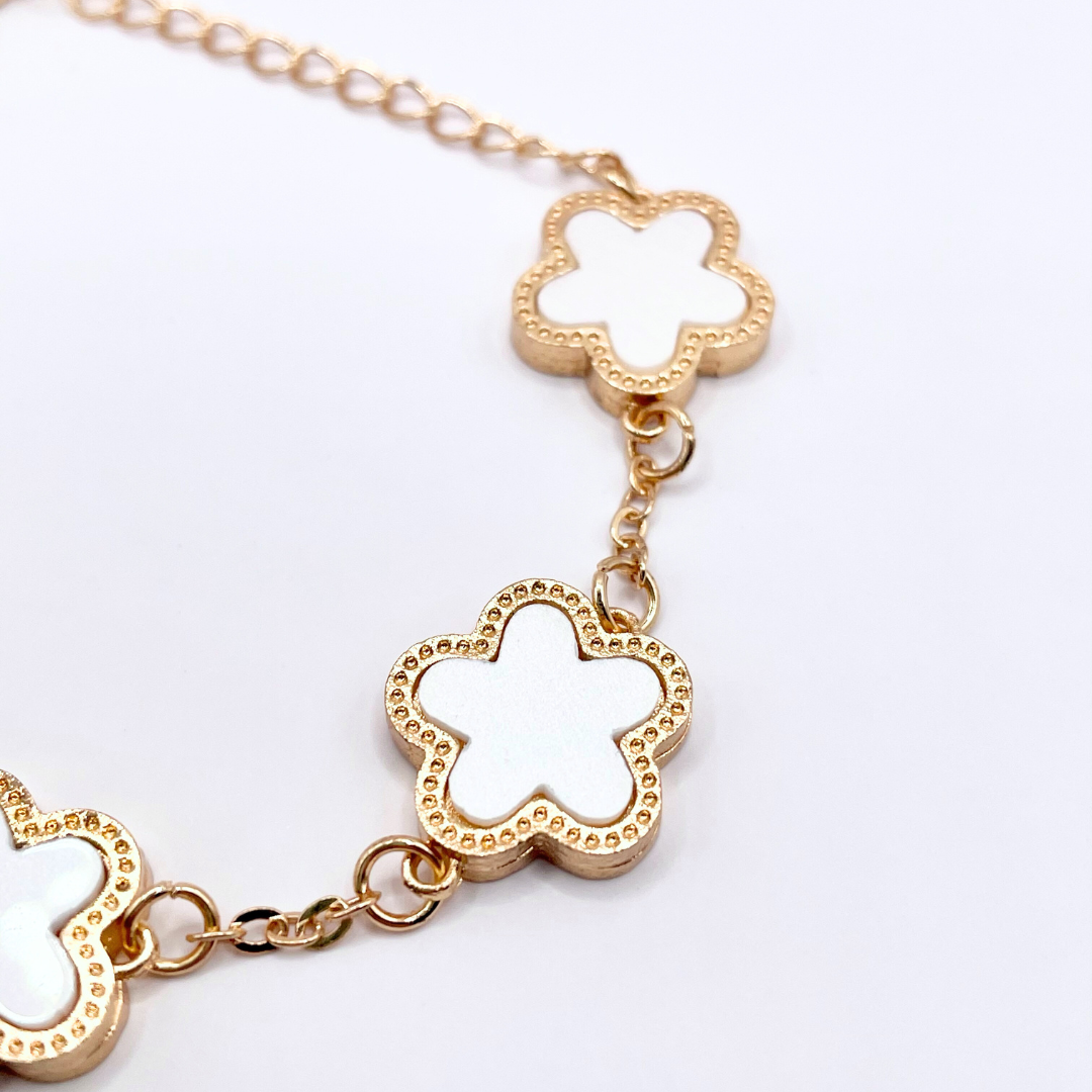 close up of flower detail on gold dainty bracelet