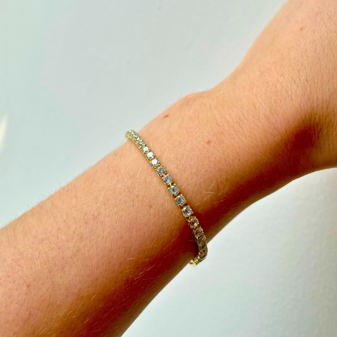 person wearing gold 3mm cubic zirconia tennis bracelet
