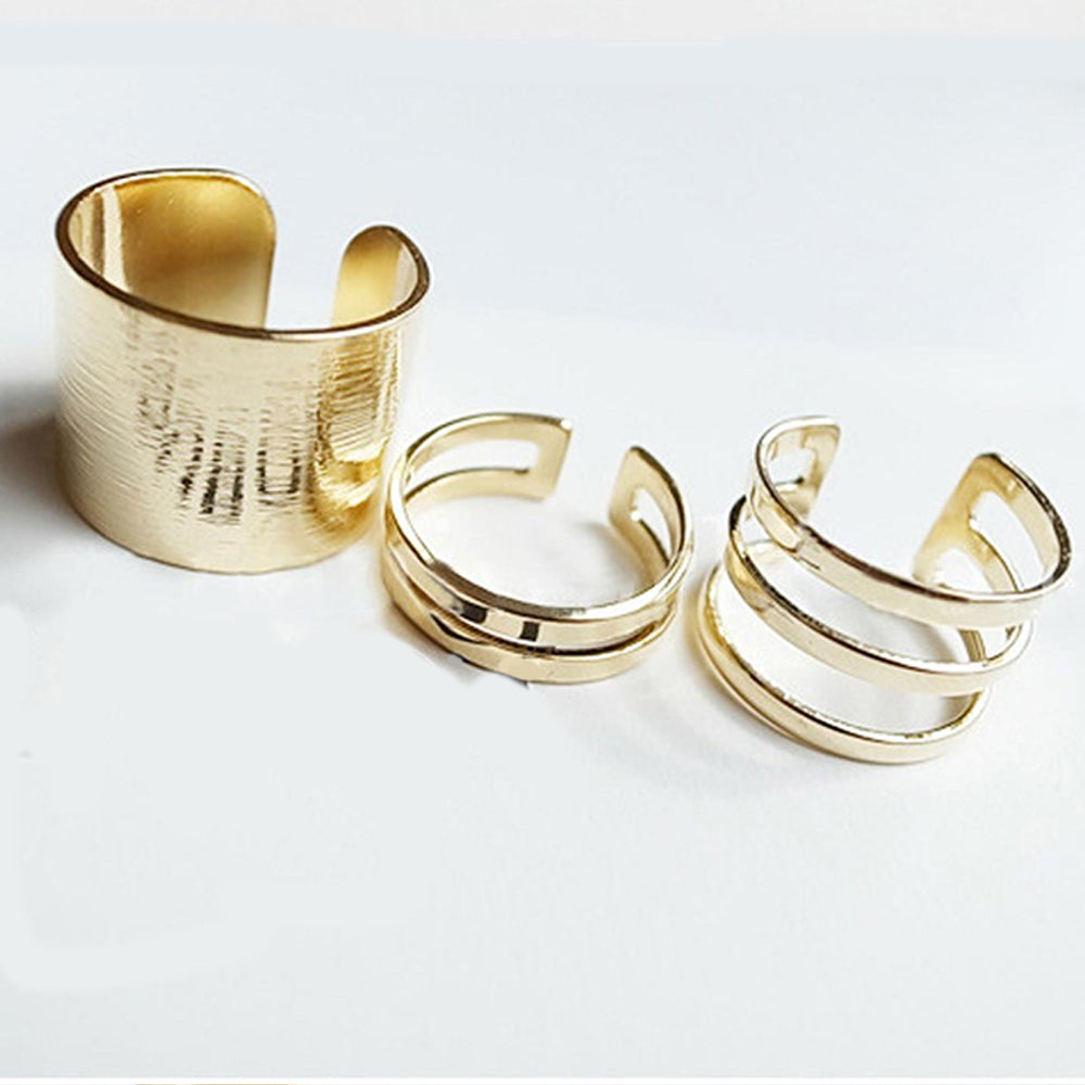 The set of three Kelabu chunky stacking rings in Gold set out in a line on a plain white background