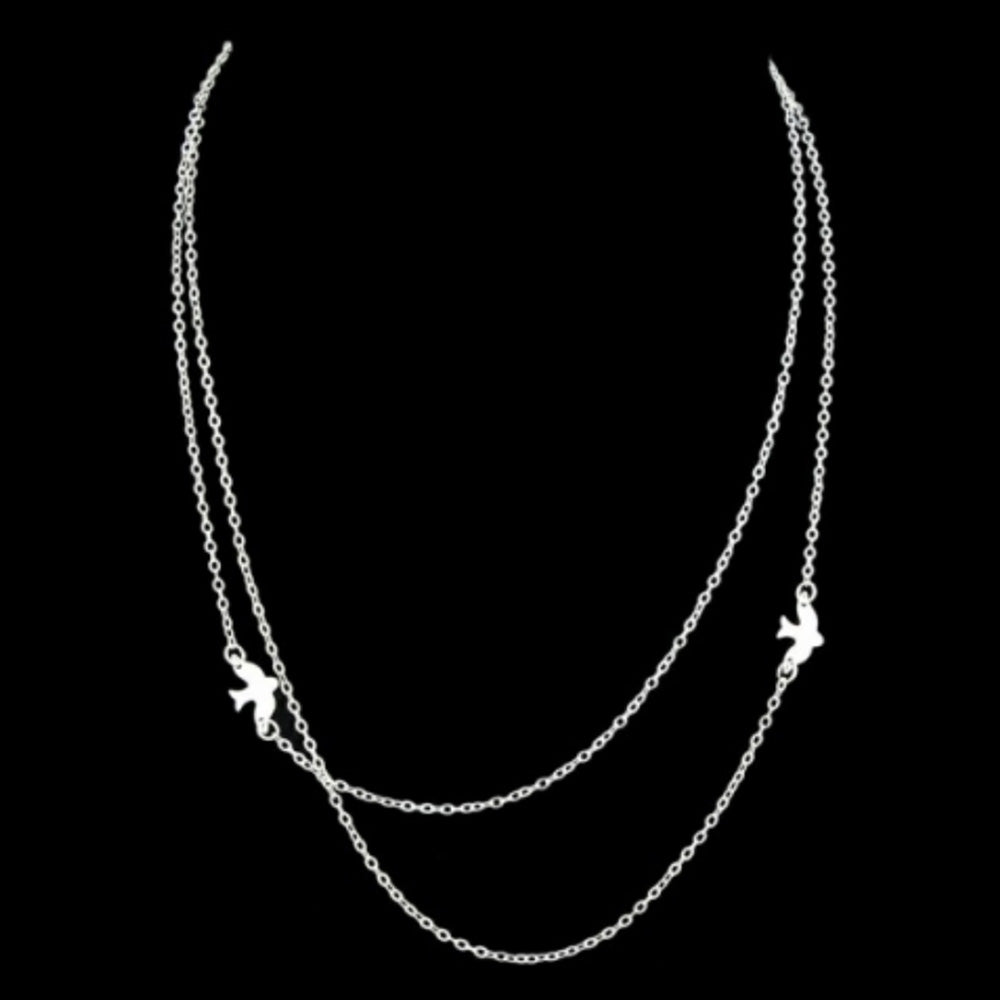 The silver Kelabu double layer necklace with beautiful bird charm on a black background