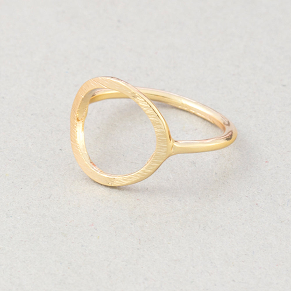 The Kelabu Karma Circle bohemian rings in Gold on a light coloured background