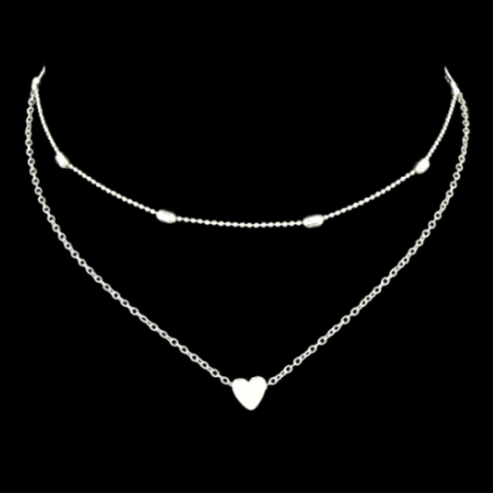 The beautiful Kelabu silver heart charm necklace and choker set pictured on a plain black background