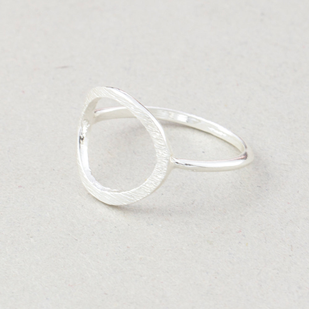 The Kelabu Karma Circle bohemian rings in silver on a light coloured background