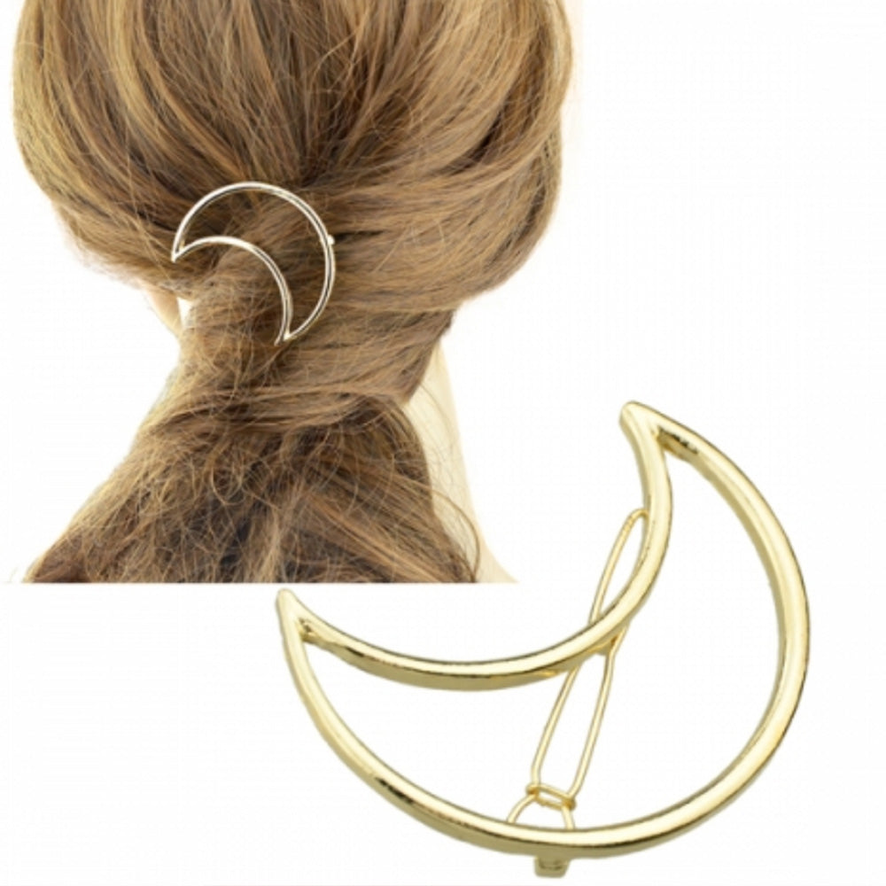 Woman with long blonde brown hair wearing the gold Kelabu cut out moon hair clip as a feature piece in a twisted ponytail