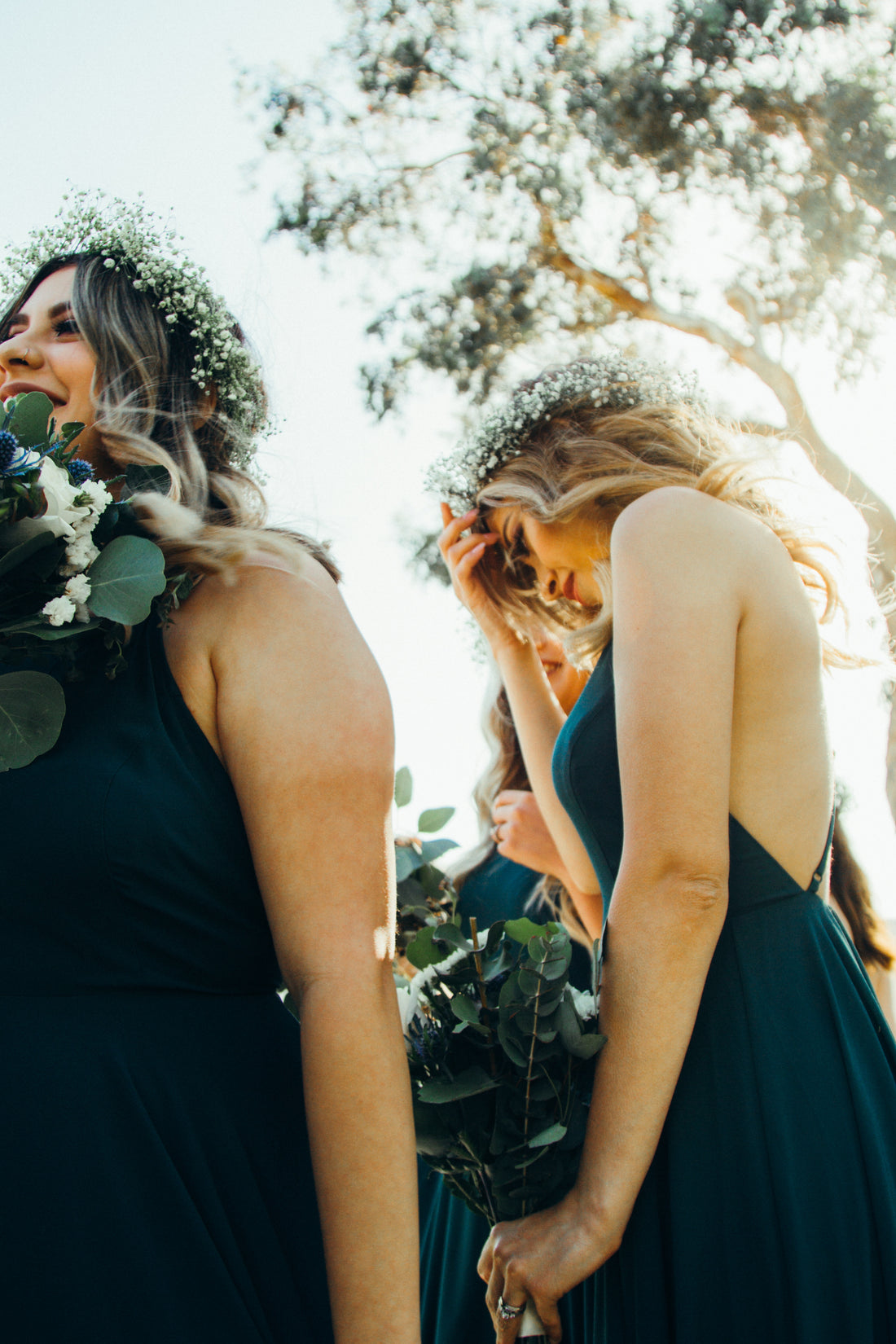 two women as bridesmaids wearing bridesmaid jewellery and carrying flower bouquets