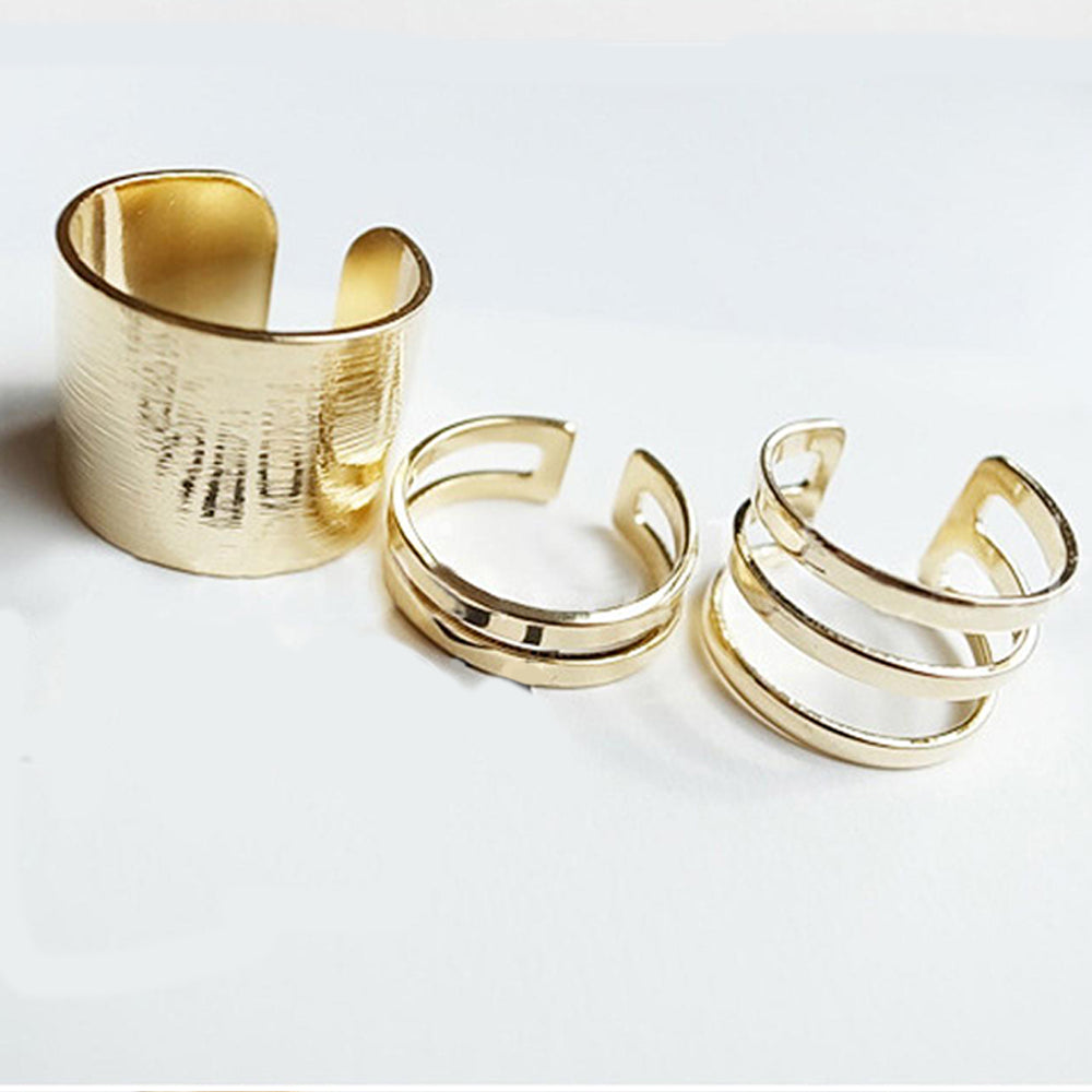The set of three Kelabu chunky stacking rings in Gold set out in a line on a plain white background 