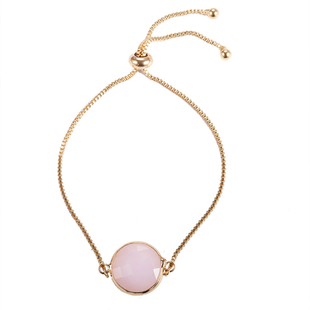 Our beautiful Kelabu beaded tie bracelet with gold chain and pink pendant on a plain white background 