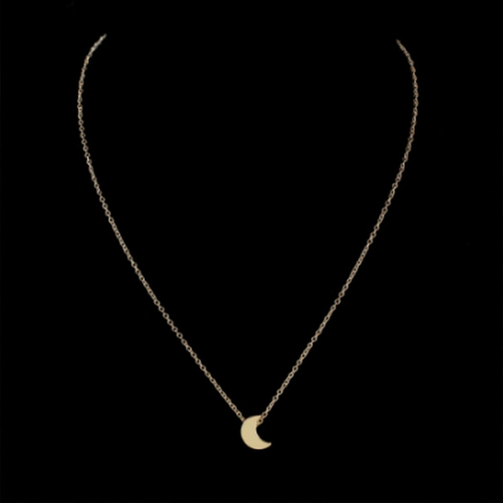 The Kelabu dainty moon pendant necklace in Gold on a black background