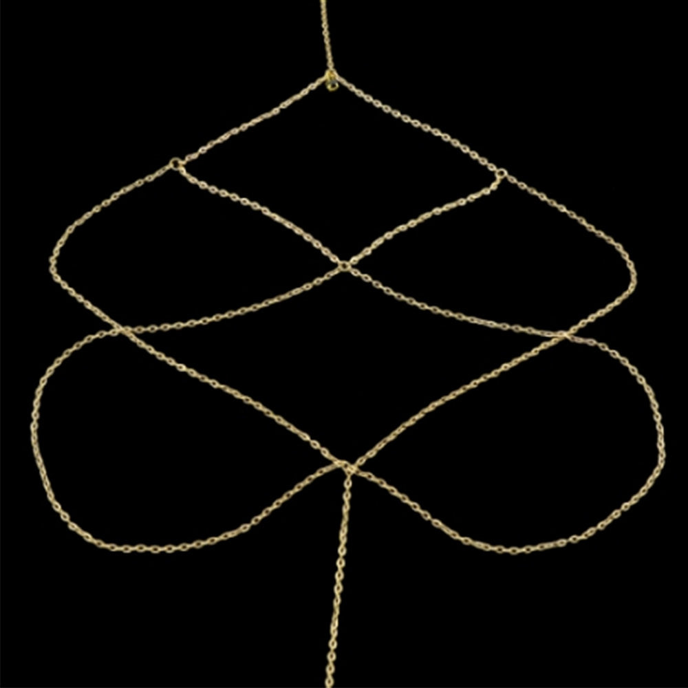 The Kelabu diamond detail leg chain in gold laid out flat on a black background 