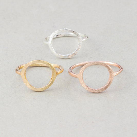 The Kelabu Karma Circle bohemian rings in all three different colours - gold, silver, and rose gold - on a light coloured background