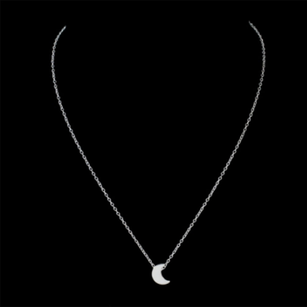 The Kelabu dainty moon pendant necklace in Silver on a black background