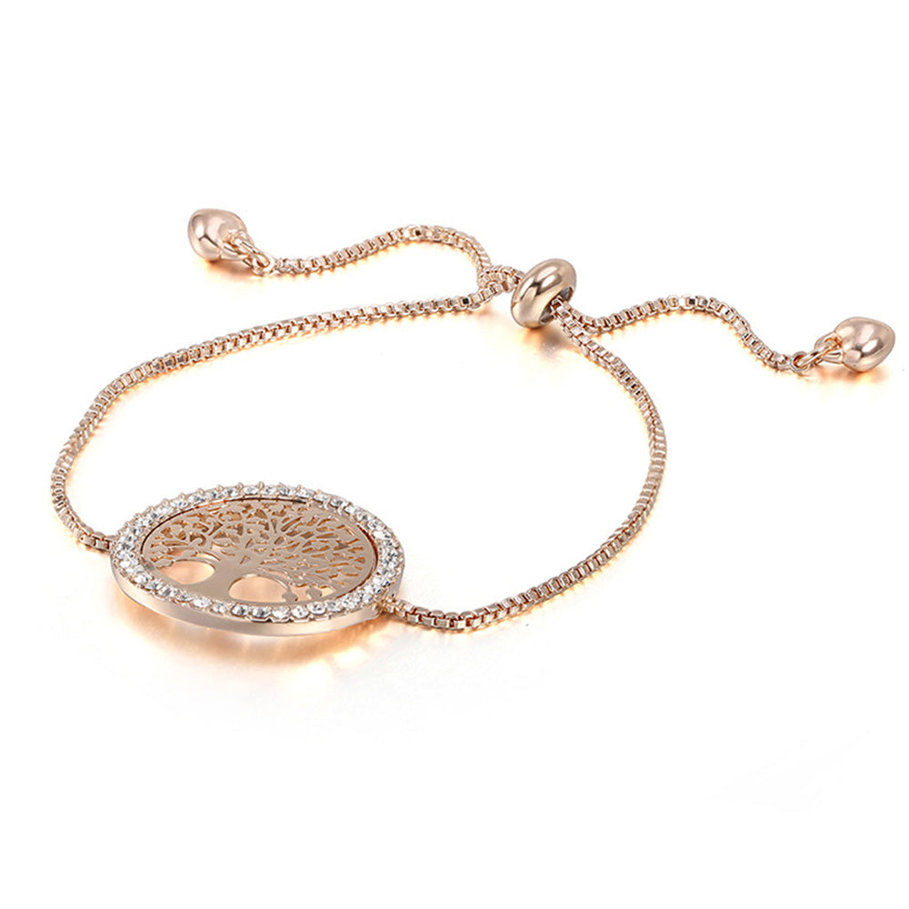 The gold tree bracelet from Kelabu featuring a delicate tree of life design with dazzling diamonds around the outer circle and a stylish tie fastening on a white background 